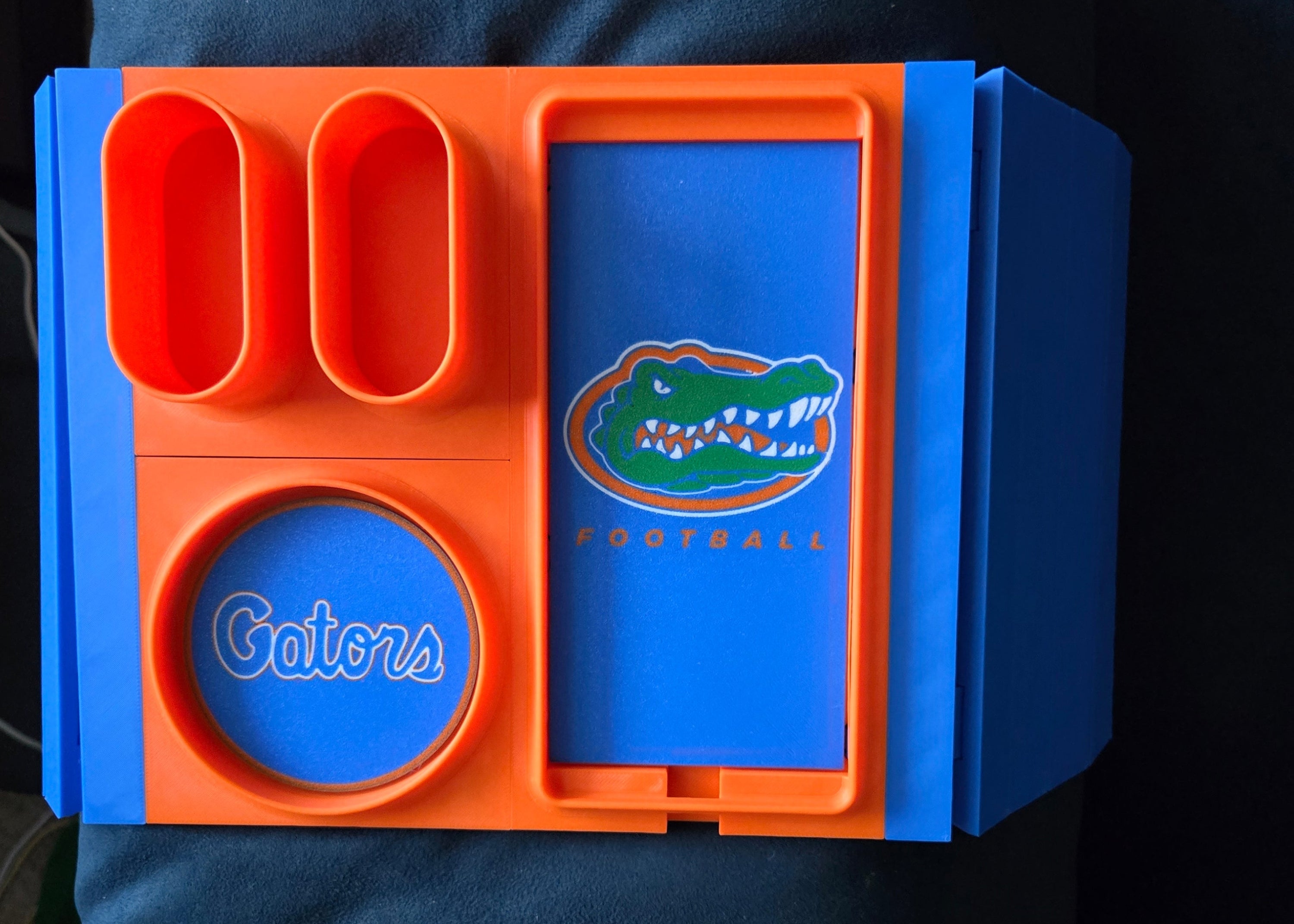 Blue and orange container with a logo on a dark blue background