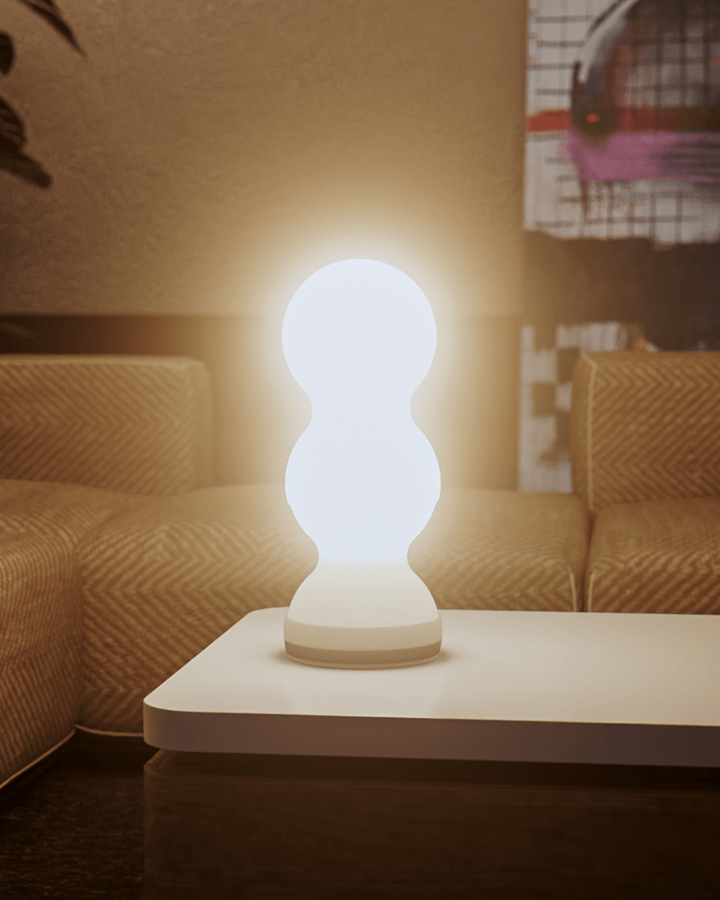 Modern table lamp on a coffee table with a cozy living room background