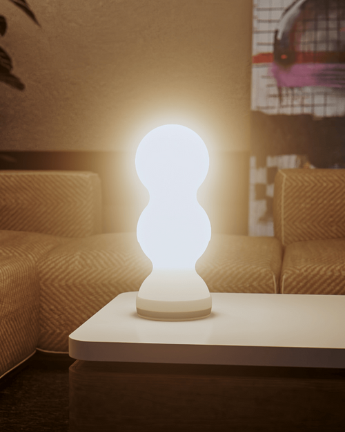 Modern table lamp on a coffee table with a cozy living room background