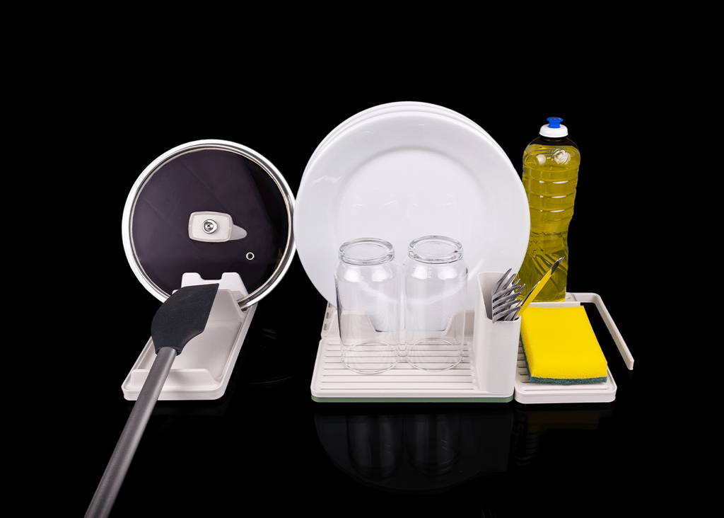 Dish drying rack with plates, glasses, and a bottle of dish soap on a black background