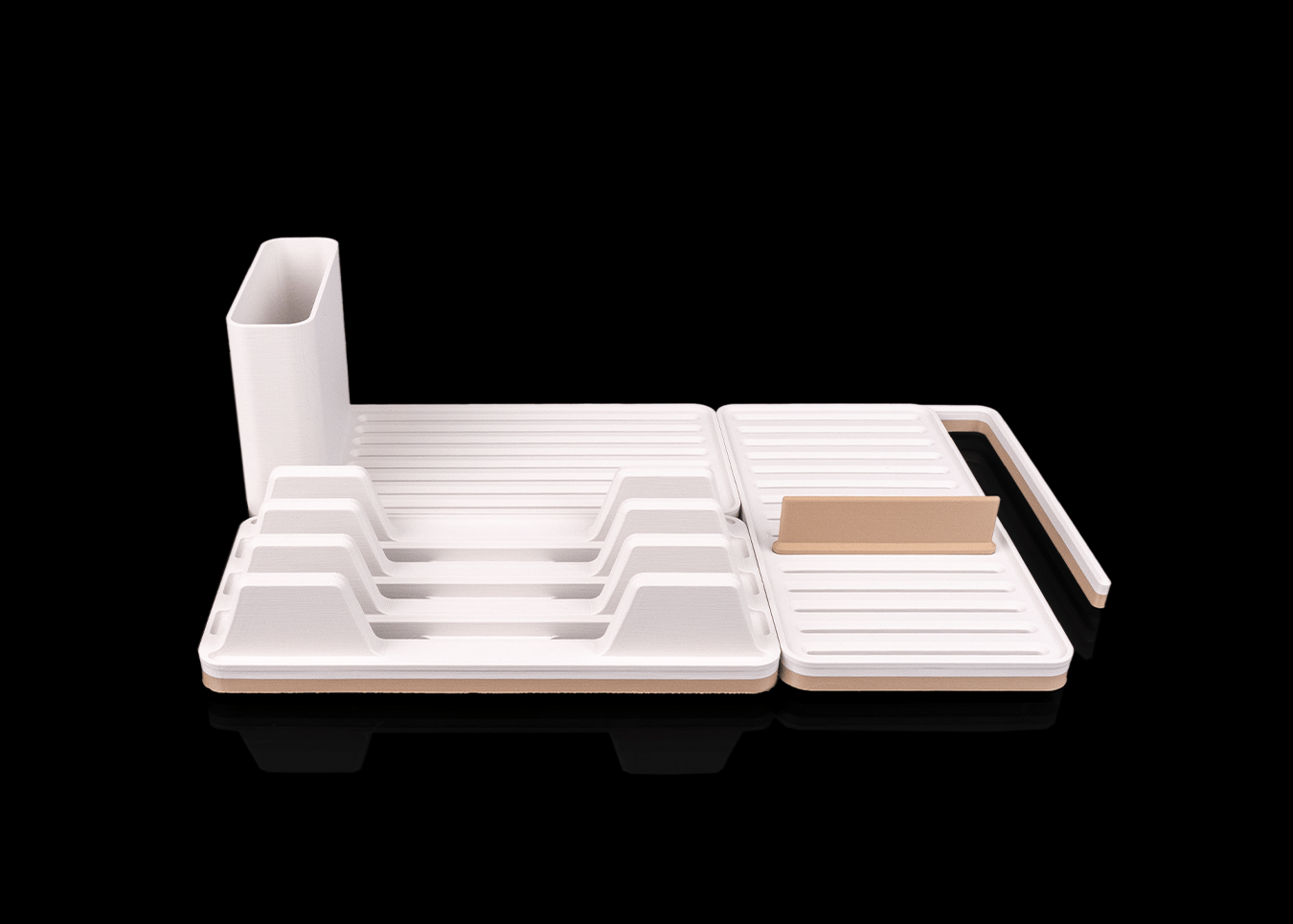 White kitchen dish rack with cutting board on a black background