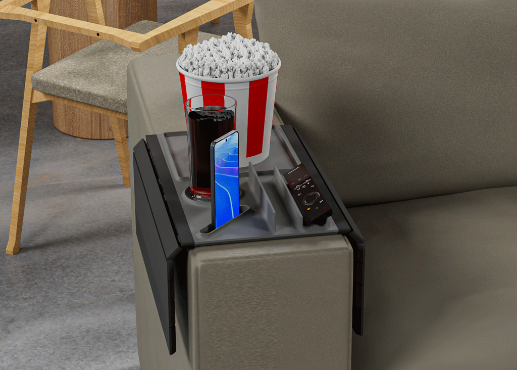 Popcorn bucket, phone, and drink on a small table next to a couch.