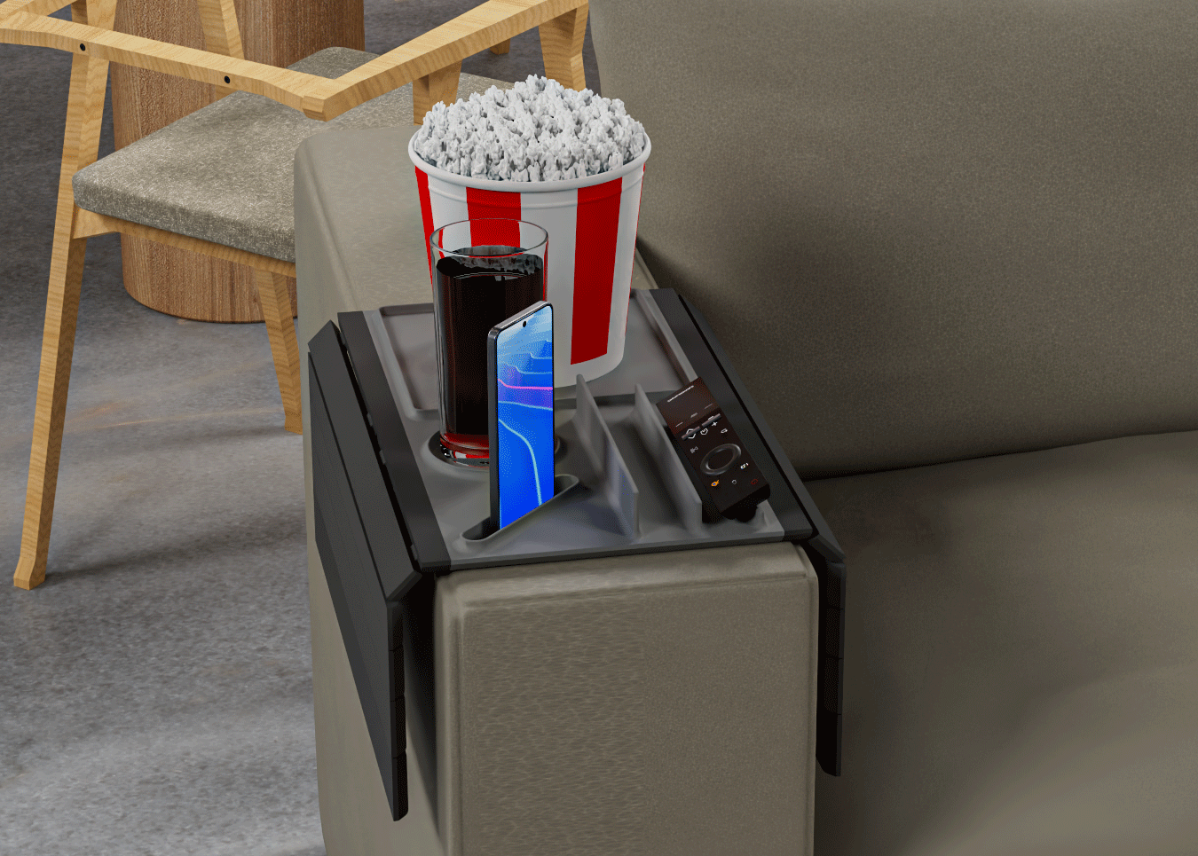 Popcorn bucket, phone, and drink on a small table next to a couch.