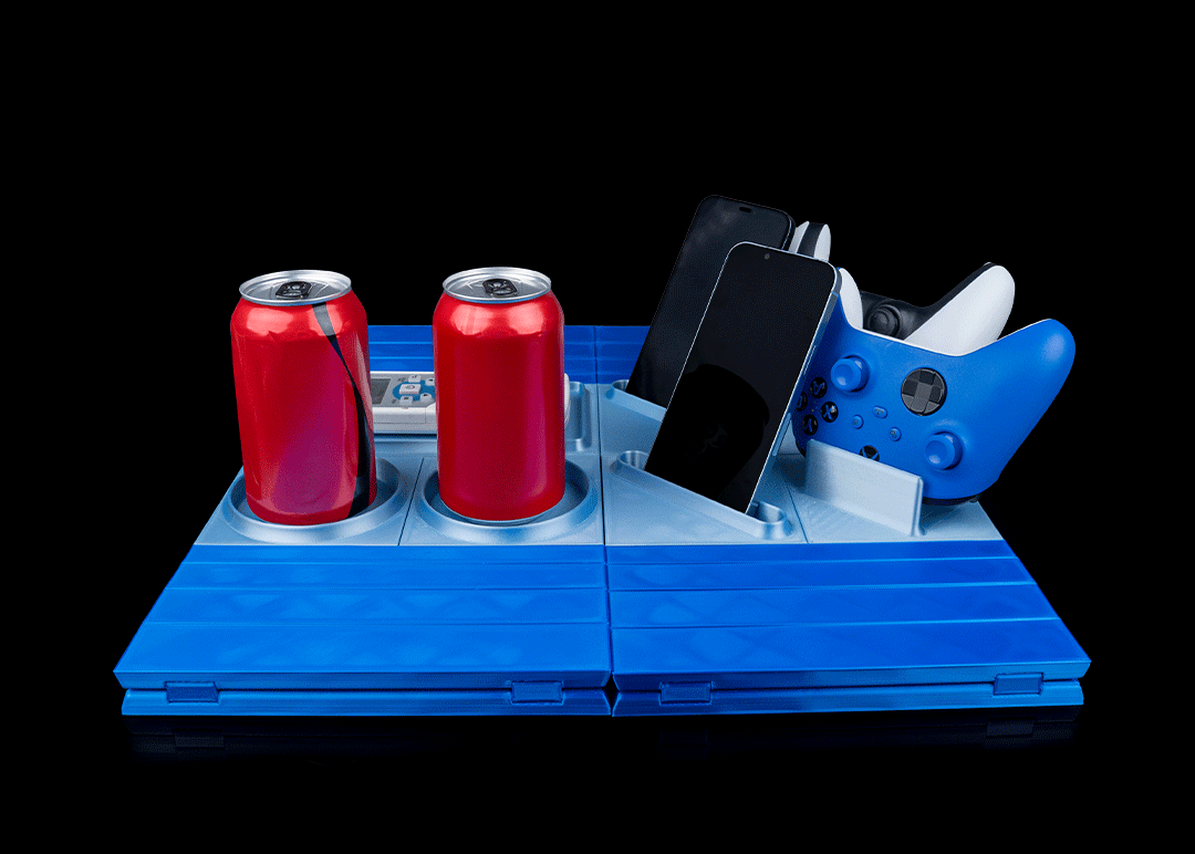 Blue folding tray with two red cans, a phone